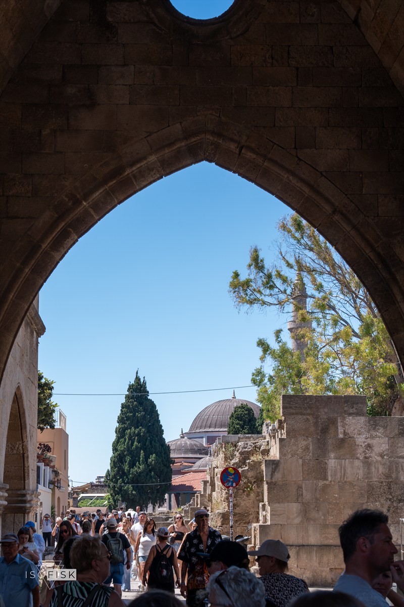 Blue sky seen through a dark pointed stone arch