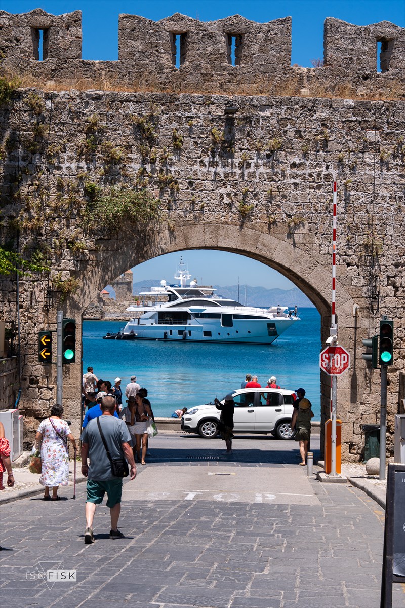 Stone gateway framing a yacht in the harbour