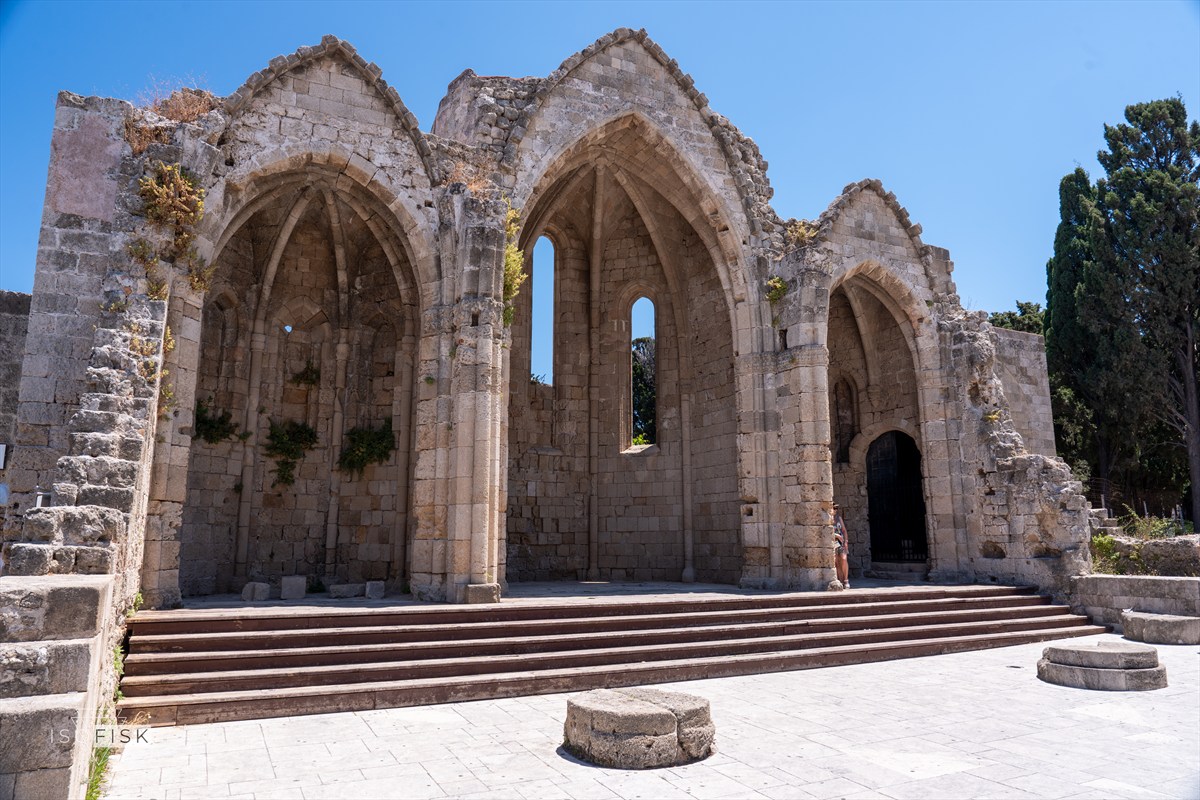 Three pointed stone arches in a ruined building