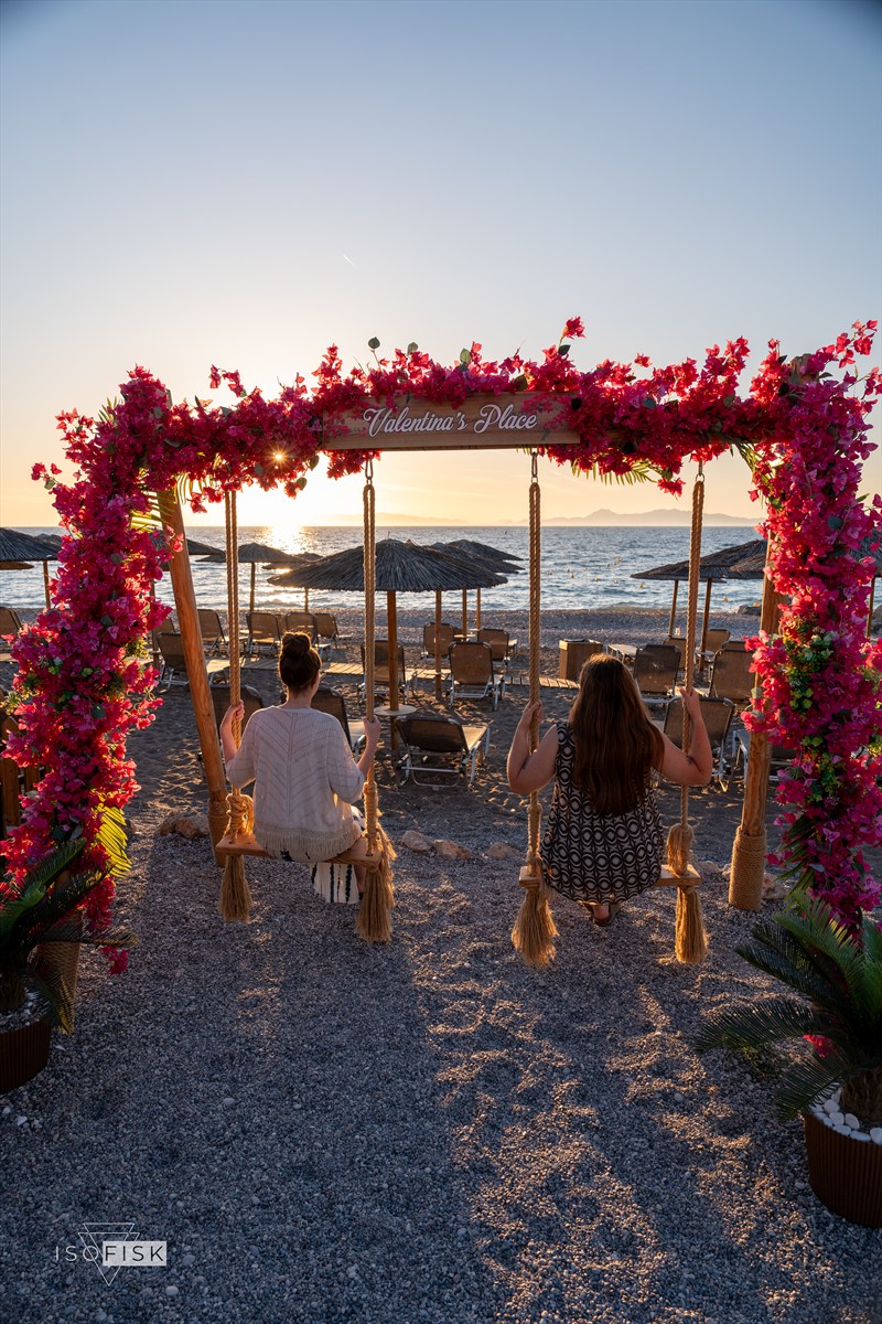 Flower-covered swing frame glowing in the setting sun
