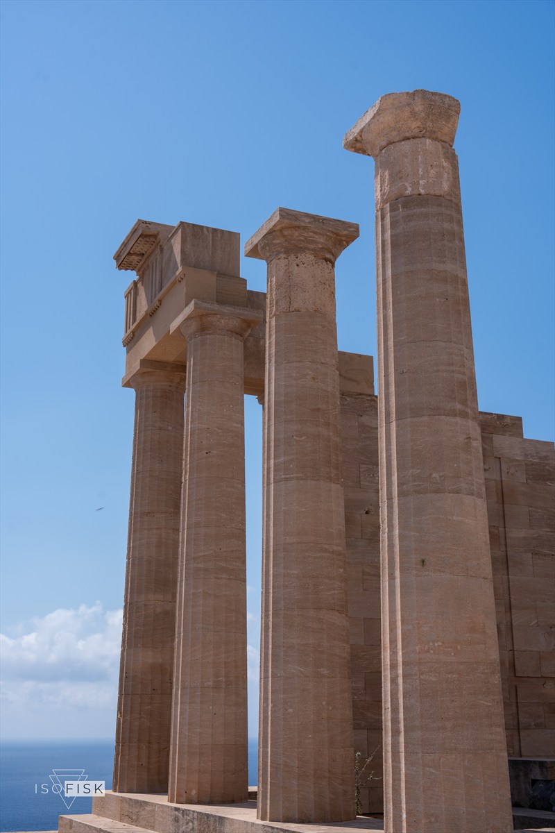 Ancient stone columns against a clear blue sky