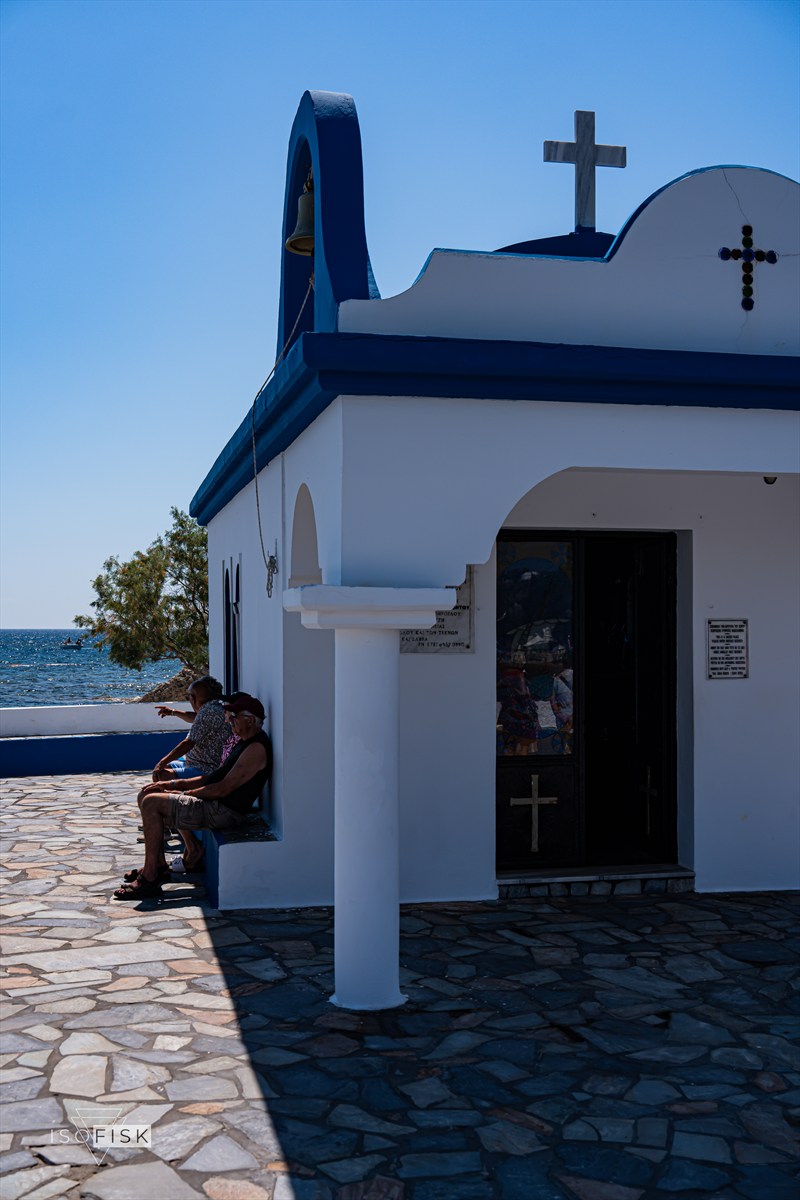 Small white chapel beside the blue sea
