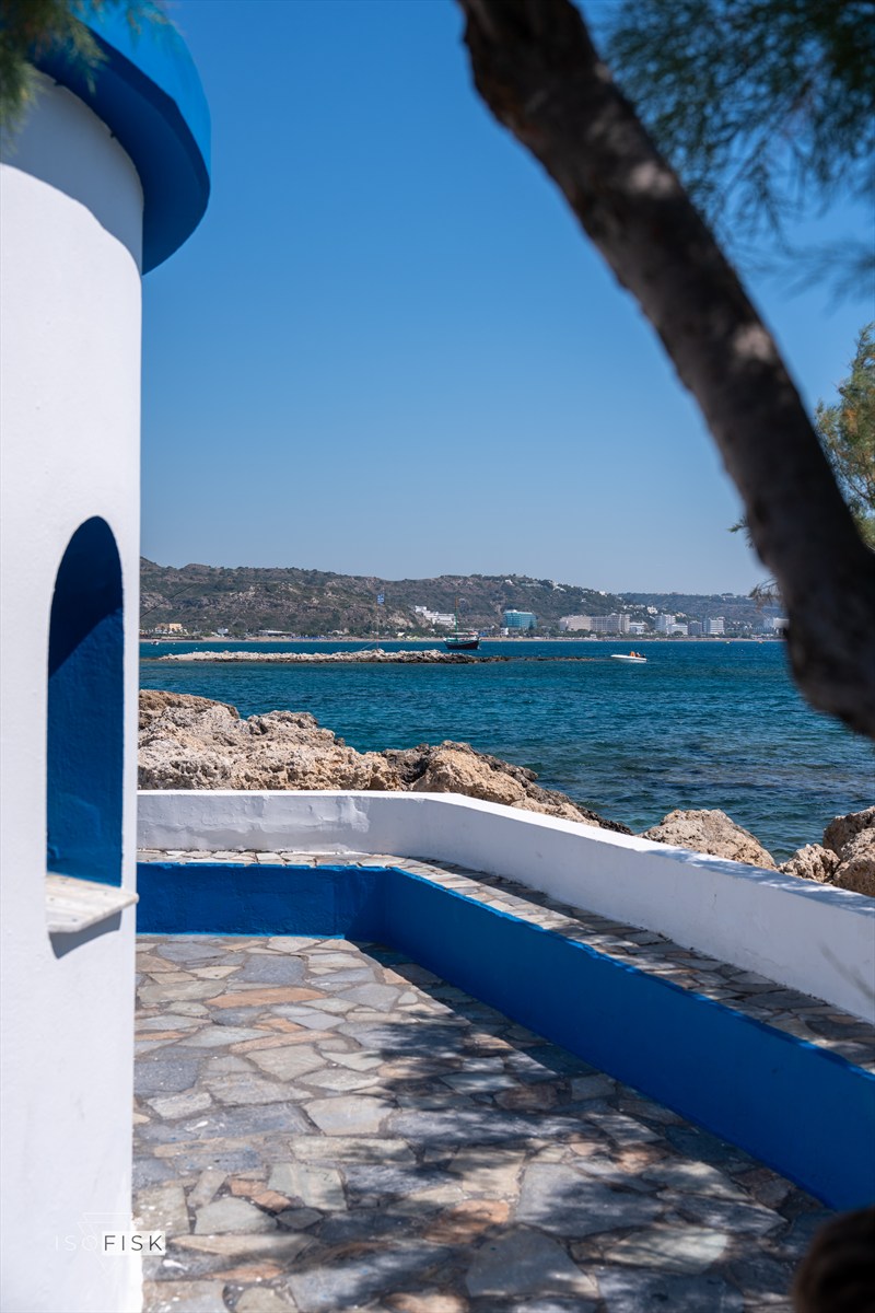 White and blue waterfront architecture framing the sea