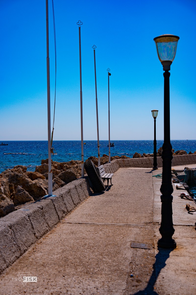 Harbour walkway with lamp posts and boat masts