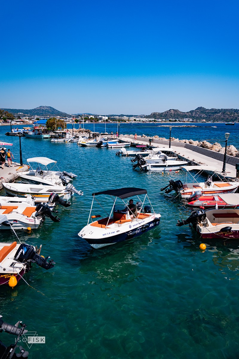 Small boats moored in a turquoise marina