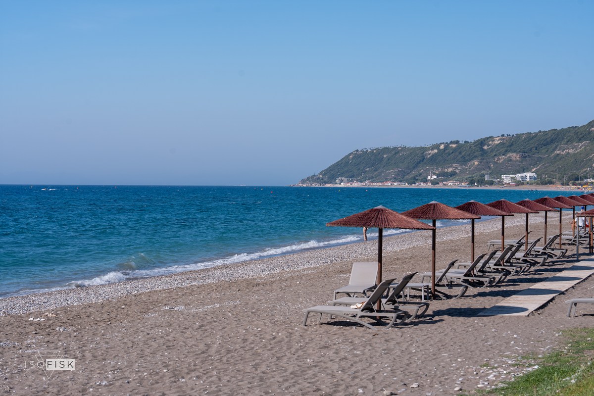 Beach sunbeds and parasols beside the sea