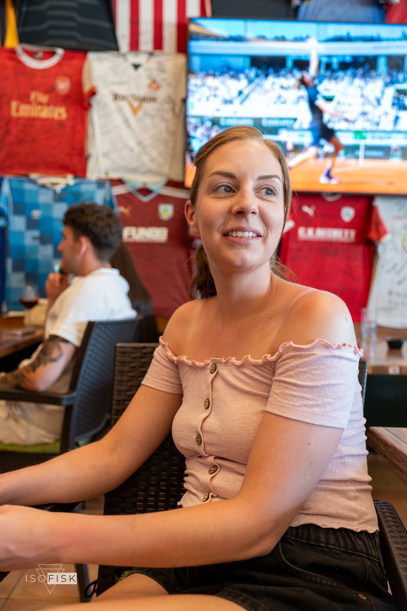 Person smiling inside a busy market